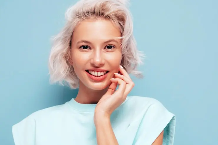 Smiling woman with short blonde hair