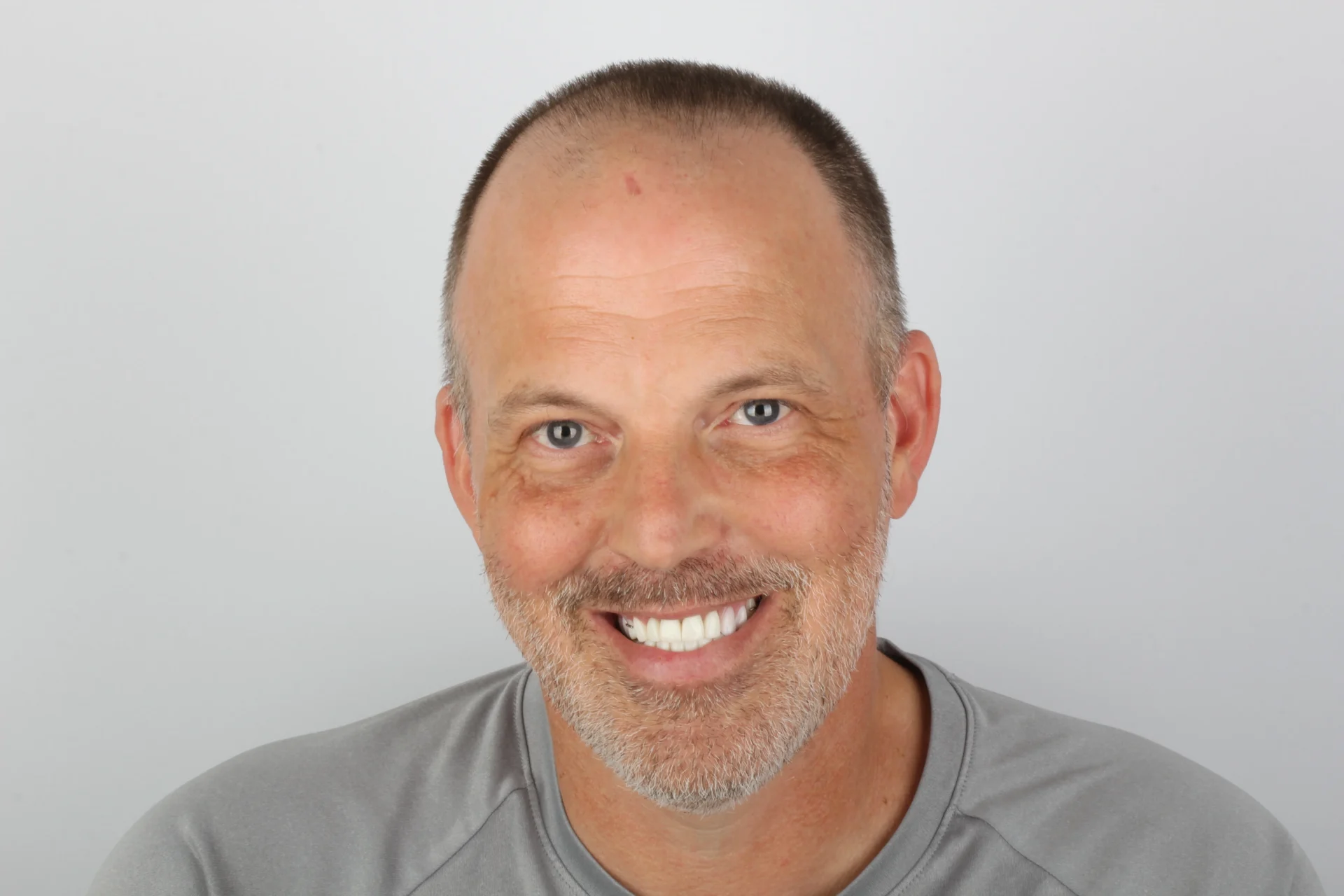Smiling man with short hair