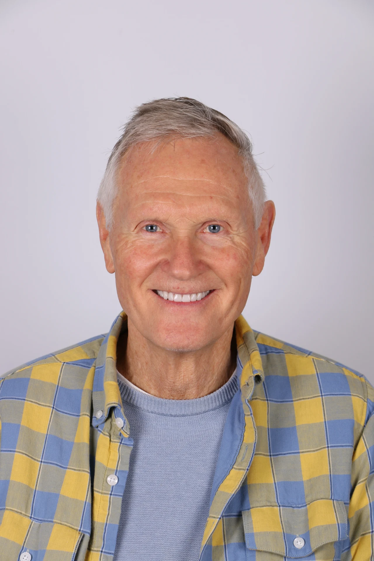 Smiling older man in plaid shirt