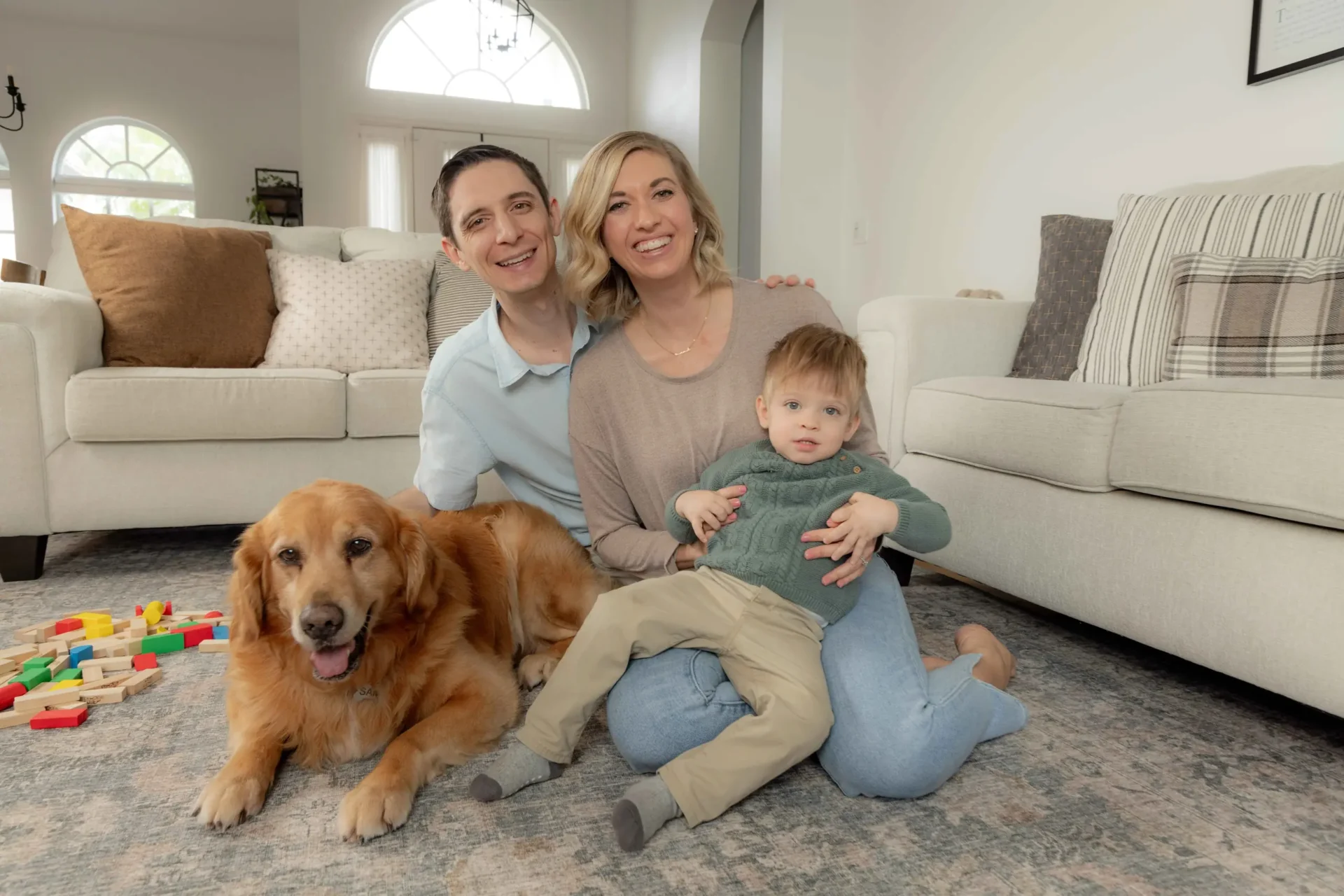 Family with dog on living room floor