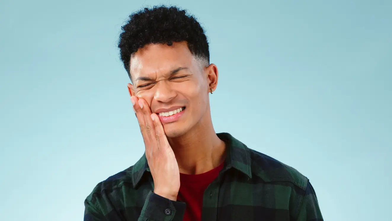 Person experiencing jaw pain or discomfort