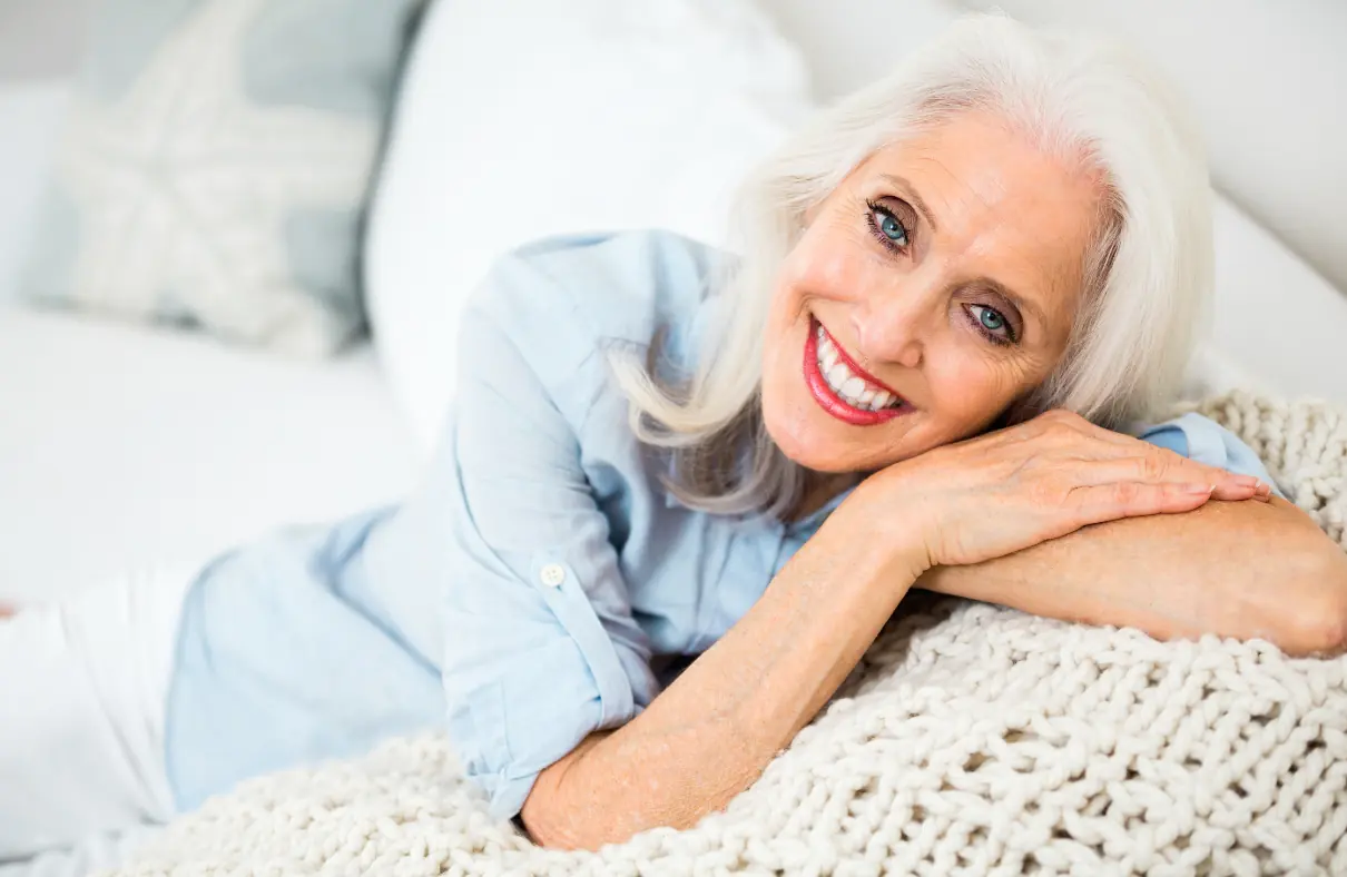 Smiling elderly woman on couch