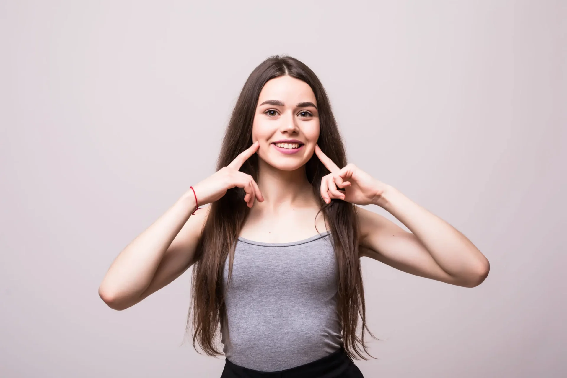 Young woman smiling and showing teeth.