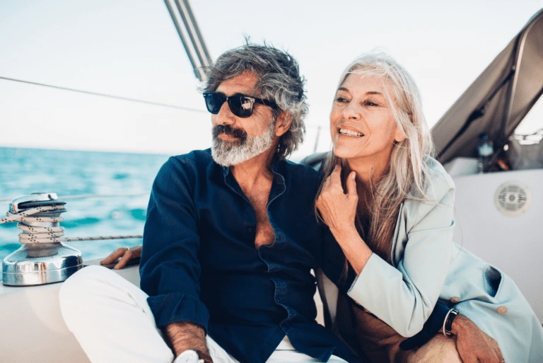 Couple enjoying time on a sailboat.
