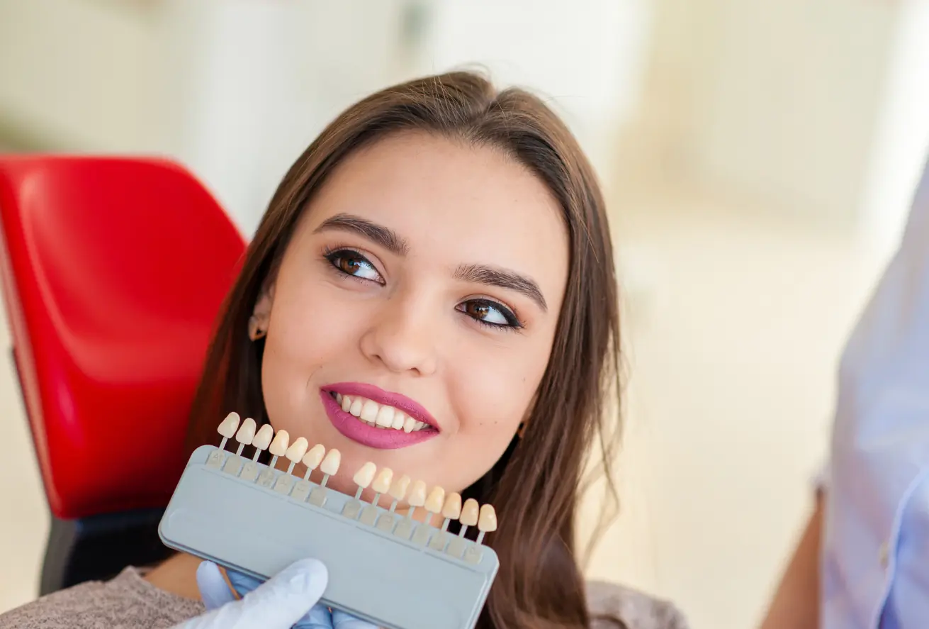 Smiling woman choosing dental shades