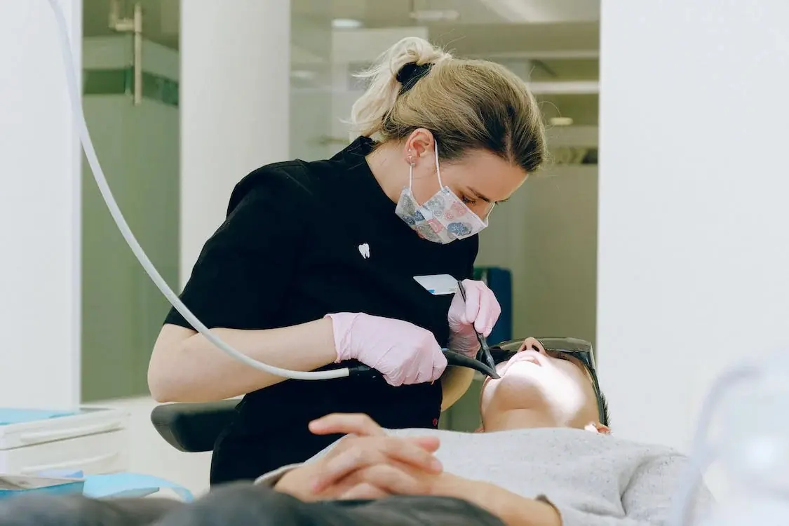 Dentist treating patient in clinic