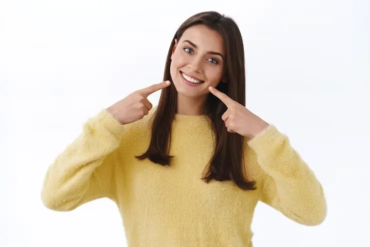 Smiling woman in yellow sweater.