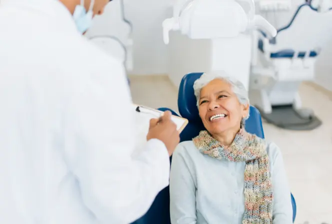 Elderly woman smiling at dentist