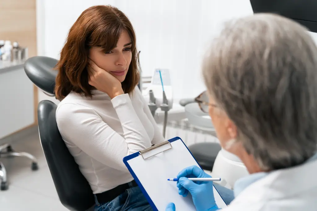 Patient consulting with a dentist.