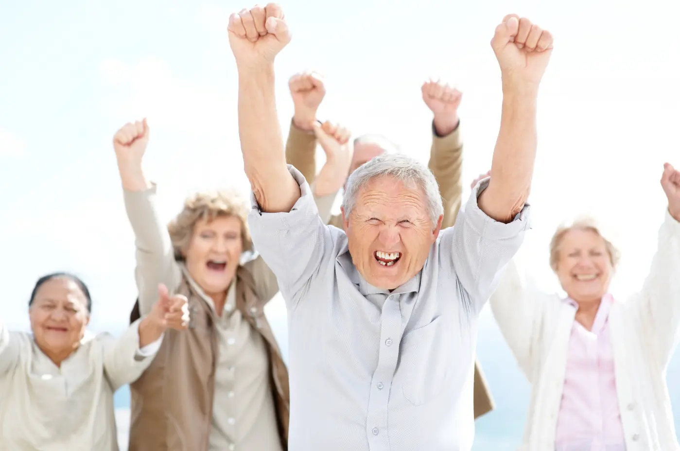 Group celebrating with raised arms